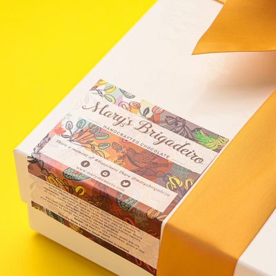 Gift box with a colorful label on a yellow background